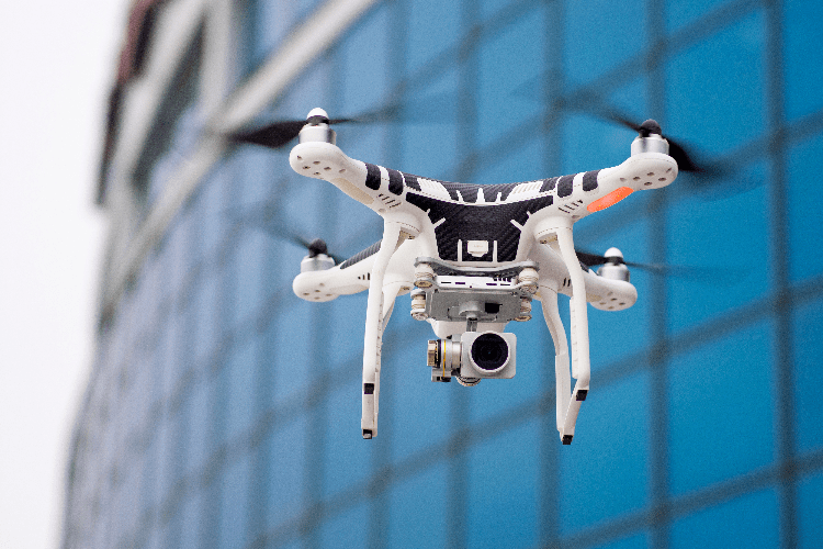 drone flying in front of tall building