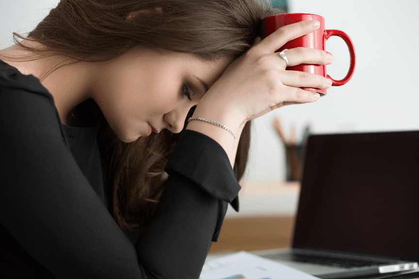 woman depressed holding red mug