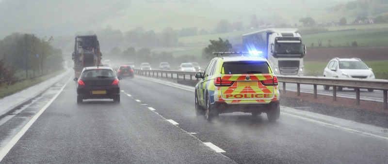 Police siren flashing blue lights driving on motorway to accident or crime scene